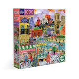 Jigsaw puzzle box featuring a colorful illustration of Paris in autumn with a pâtisserie and people on bicycles.