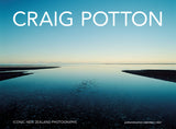 A square cover-style image featuring a calm reflective waterway between dark landforms under a clear blue sky, with the large white text 'CRAIG POTTON' across the top and smaller text at the bottom reading 'ICONIC NEW ZEALAND PHOTOGRAPHS' and 'potton&barton calendars | 2027'.
